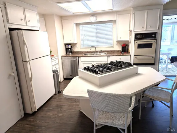 a kitchen with a table and a refrigerator