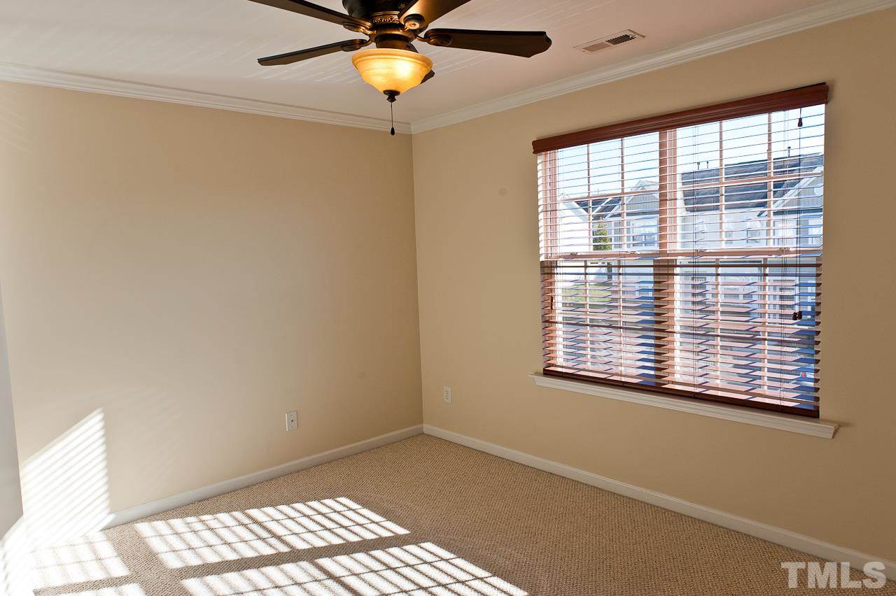 7874 Spungold Street Raleigh, NC 27617 - Photo 15 of 18 a view of an empty room with a window