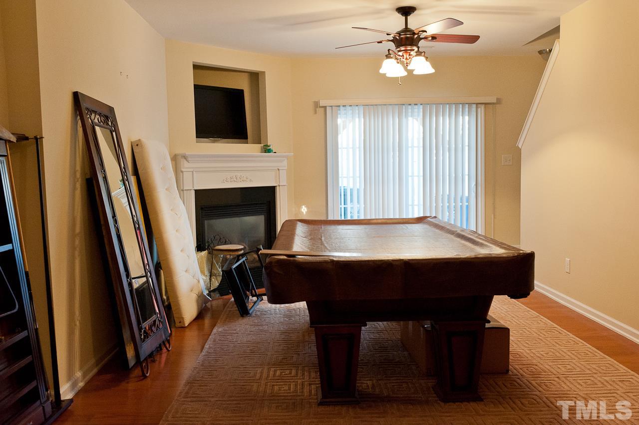 7874 Spungold Street Raleigh, NC 27617 - Photo 16 of 18 a room with furniture and a fireplace