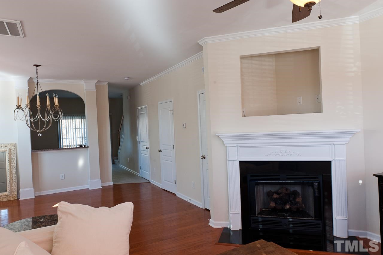 7874 Spungold Street Raleigh, NC 27617 - Photo 4 of 18 a living room with furniture and a fireplace