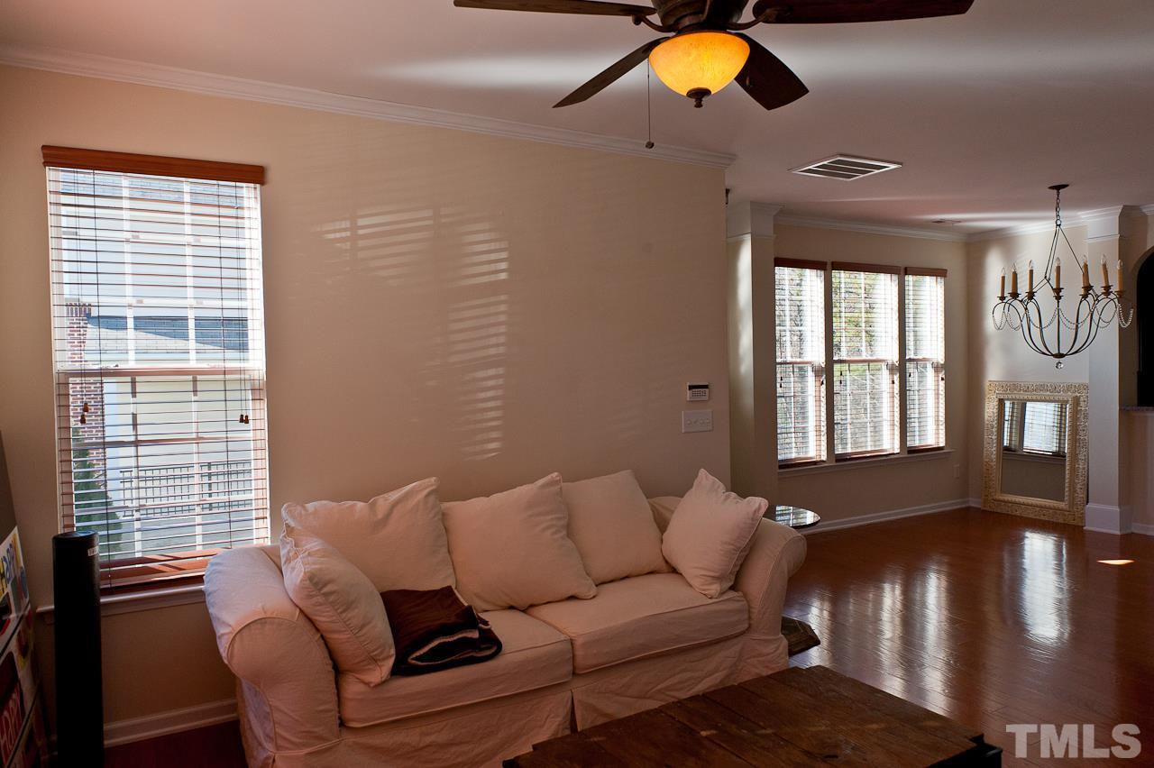 7874 Spungold Street Raleigh, NC 27617 - Photo 5 of 18 a living room with furniture and a chandelier