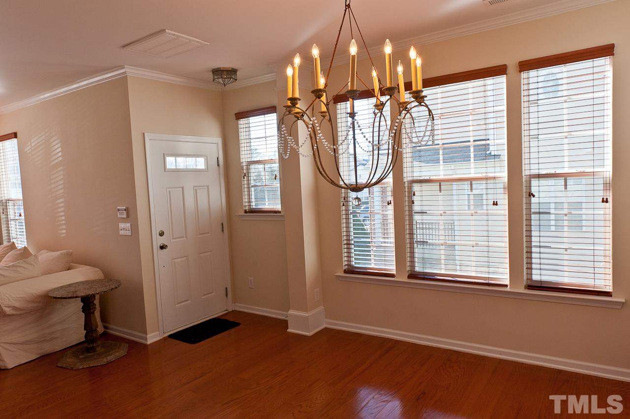 7874 Spungold Street Raleigh, NC 27617 - Photo 6 of 18 a view of a hallway with windows and chandelier