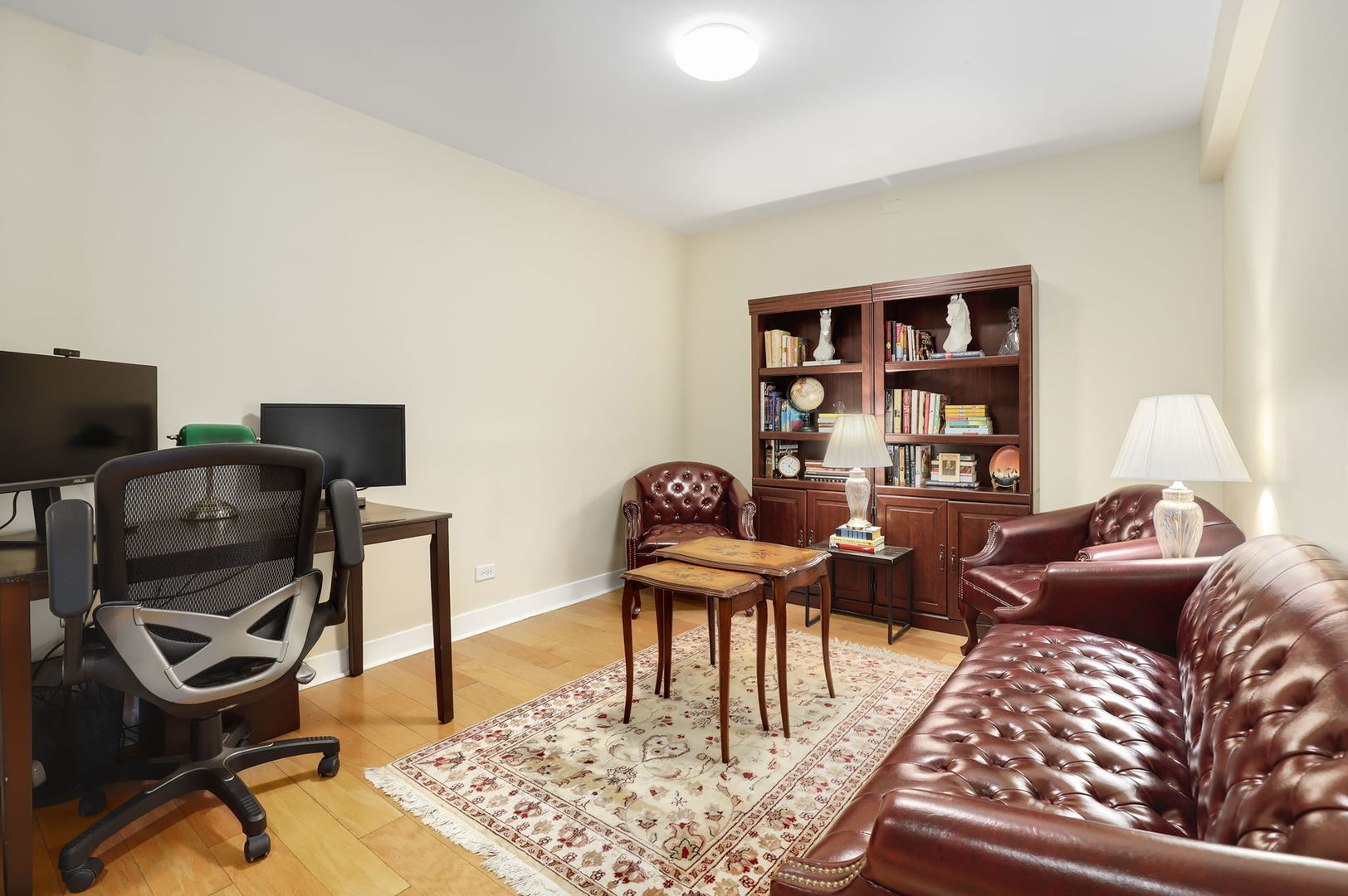 40 East 9th Street, Unit 716 Chicago, IL 60605 - Photo 25 of 37 a living room with furniture a rug and a bookshelf