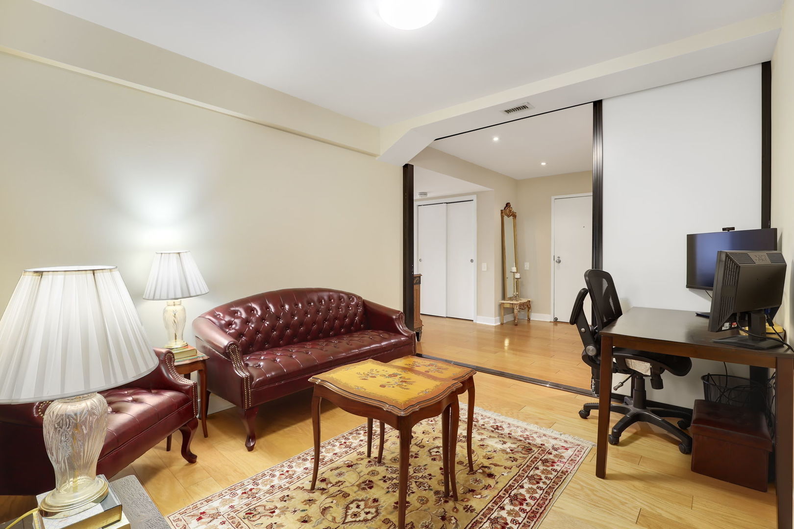 40 East 9th Street, Unit 716 Chicago, IL 60605 - Photo 26 of 37 a living room with furniture a flat screen tv and a table
