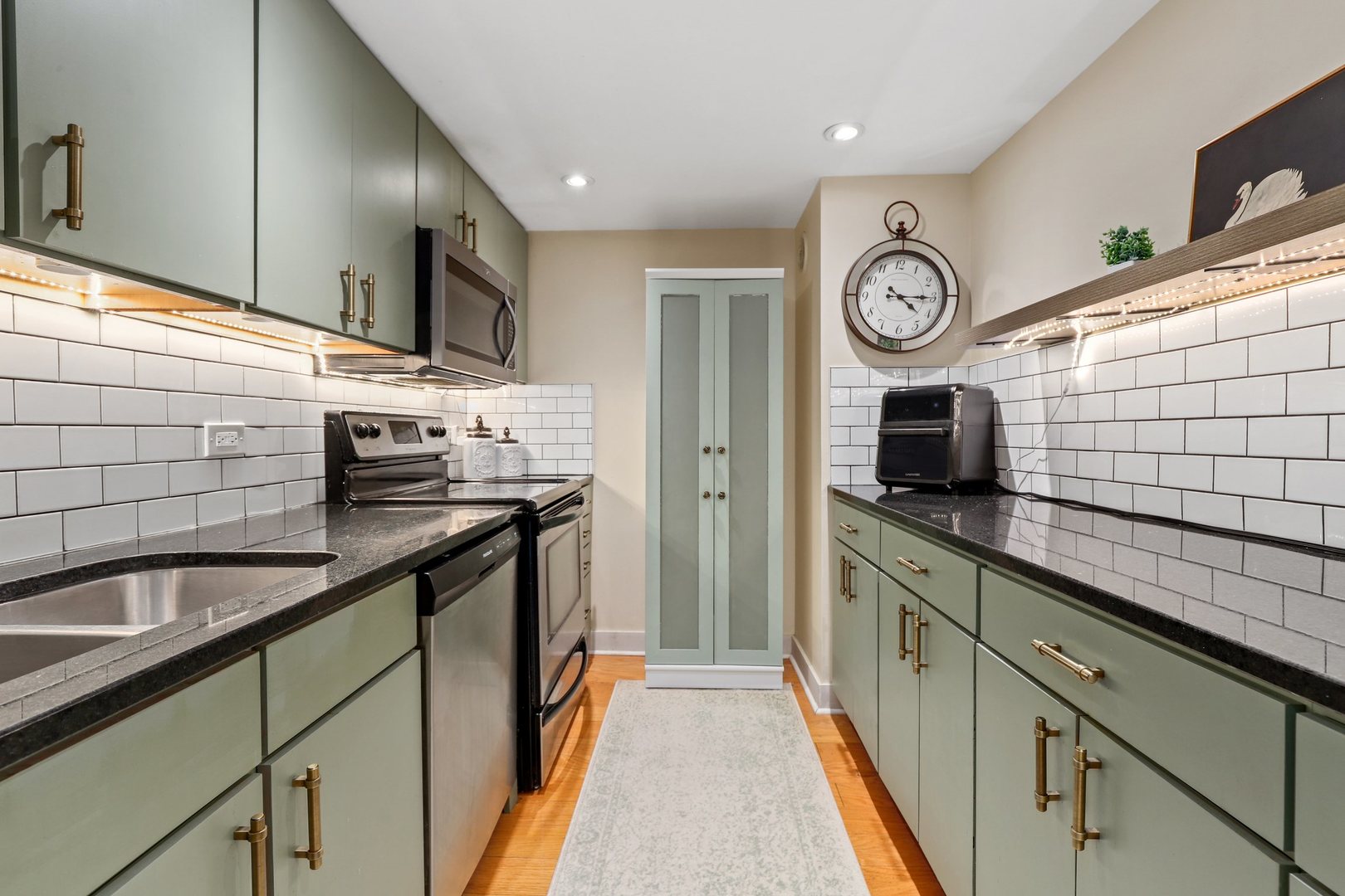 40 East 9th Street, Unit 716 Chicago, IL 60605 - Photo 10 of 37 a kitchen with stainless steel appliances granite countertop a sink and a stove