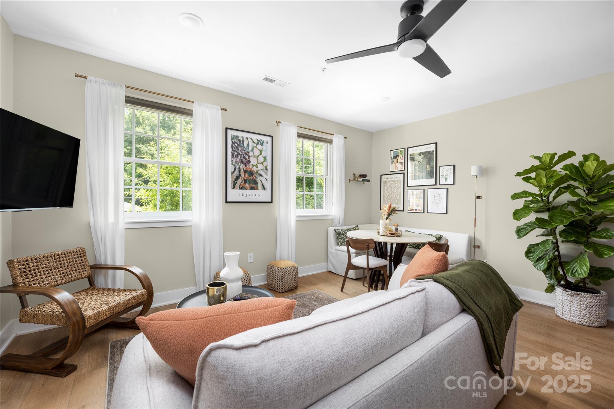 203 Grandin Road, Unit 3 Charlotte, NC 28208 - Photo 12 of 34 a hotel room with two couches a flat screen tv and a window