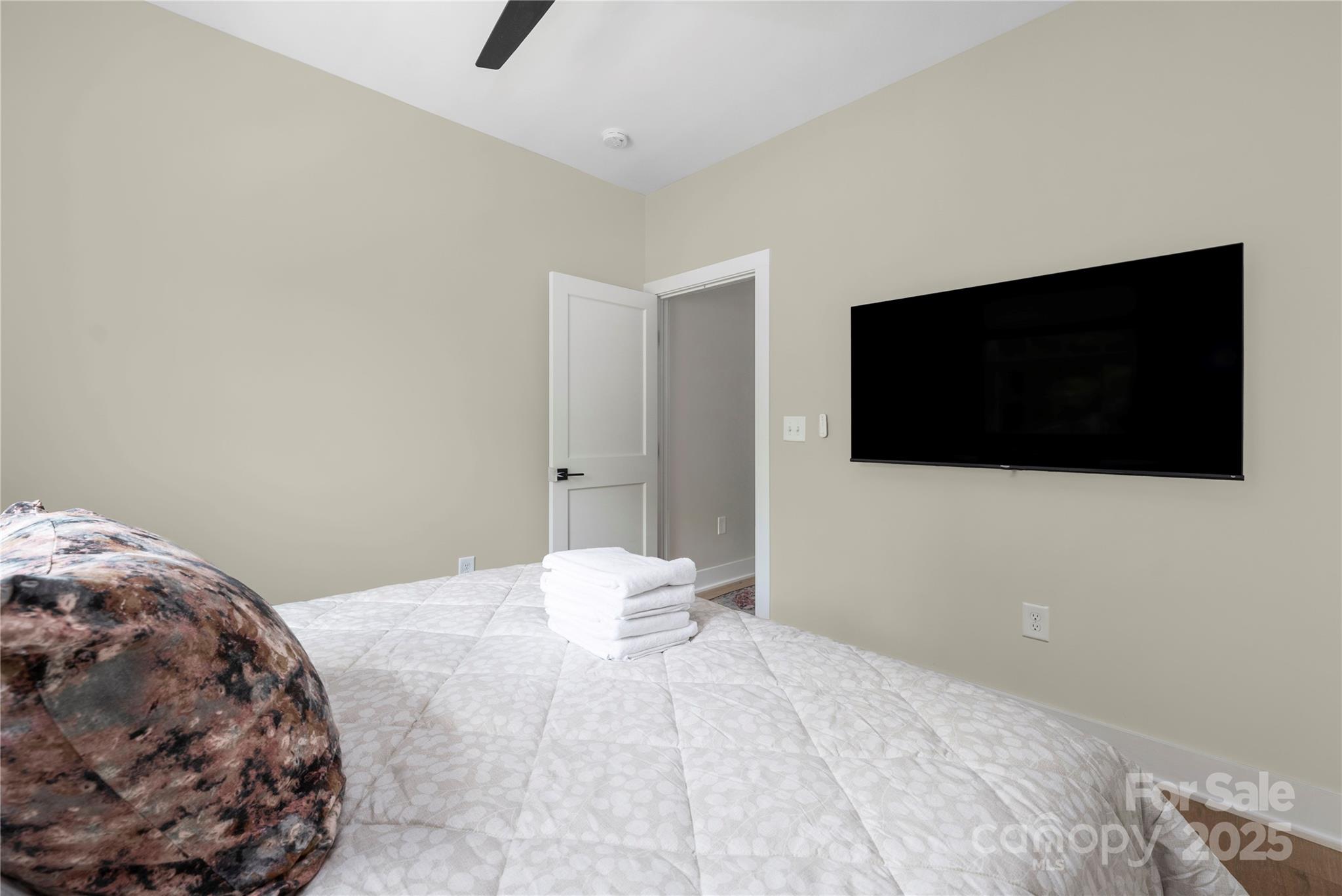 203 Grandin Road, Unit 3 Charlotte, NC 28208 - Photo 16 of 34 a bedroom with a bed and a flat screen tv