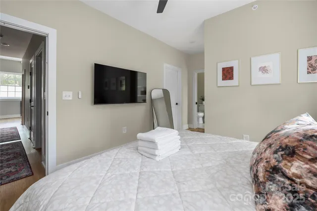 a bedroom with a bed and a mirror