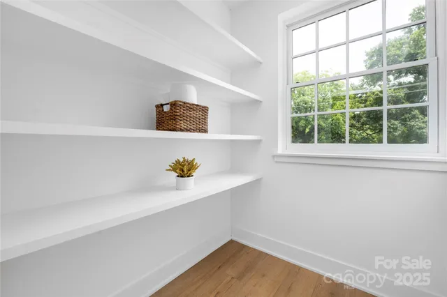 a room with a window and wooden floor