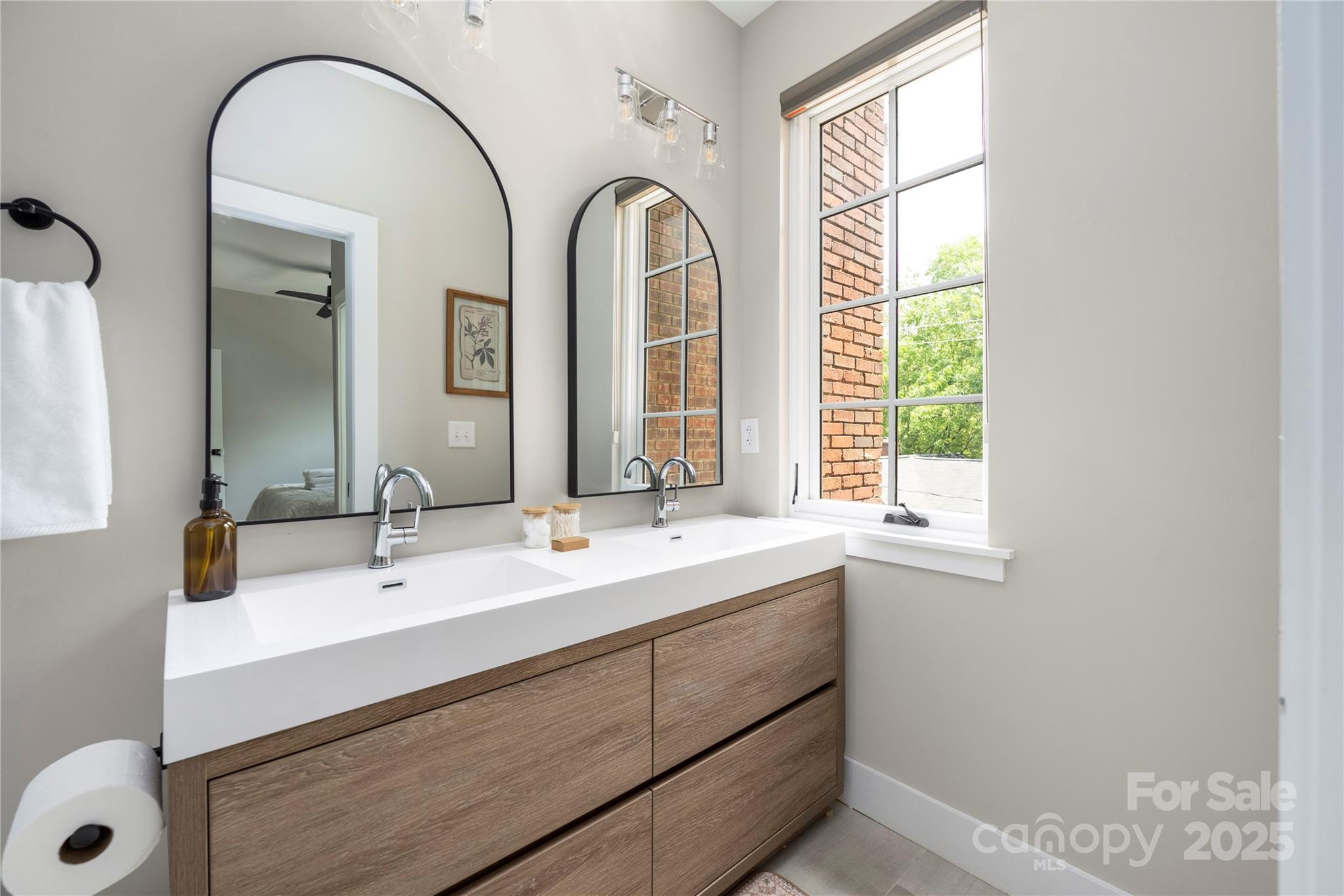 203 Grandin Road, Unit 3 Charlotte, NC 28208 - Photo 19 of 34 a bathroom with a double vanity sink a mirror and a next to a window