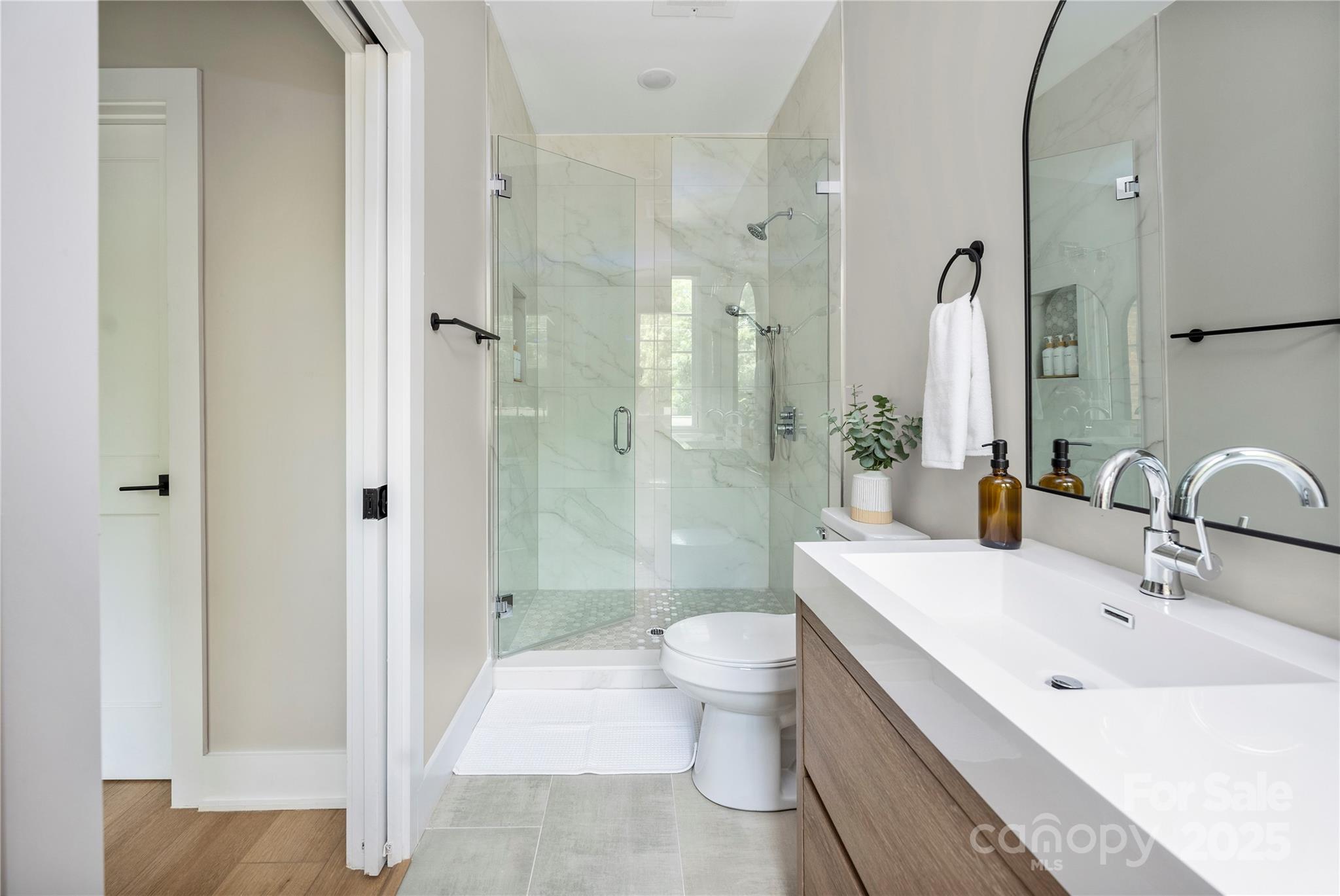 203 Grandin Road, Unit 3 Charlotte, NC 28208 - Photo 20 of 34 a bathroom with a bathtub shower sink mirror and toilet