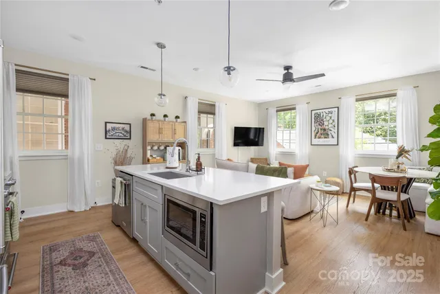 a view of kitchen island a sink and living room