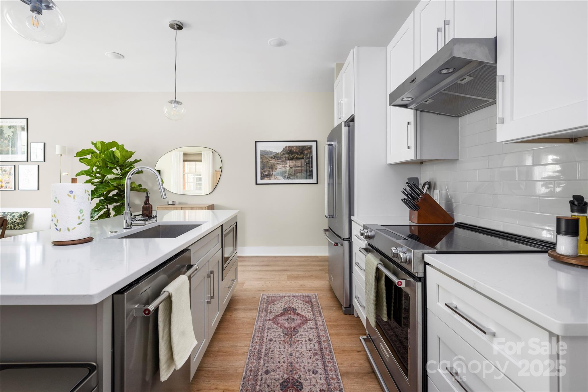 203 Grandin Road, Unit 3 Charlotte, NC 28208 - Photo 9 of 34 a kitchen with stainless steel appliances granite countertop a sink a stove and a wooden floors