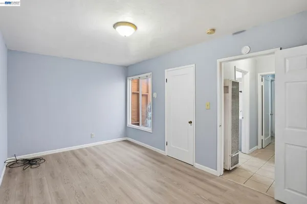 an empty room with windows and closet