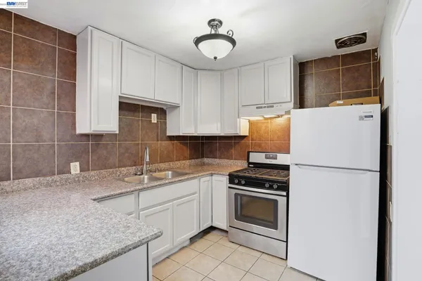 a kitchen with a sink appliances and cabinets