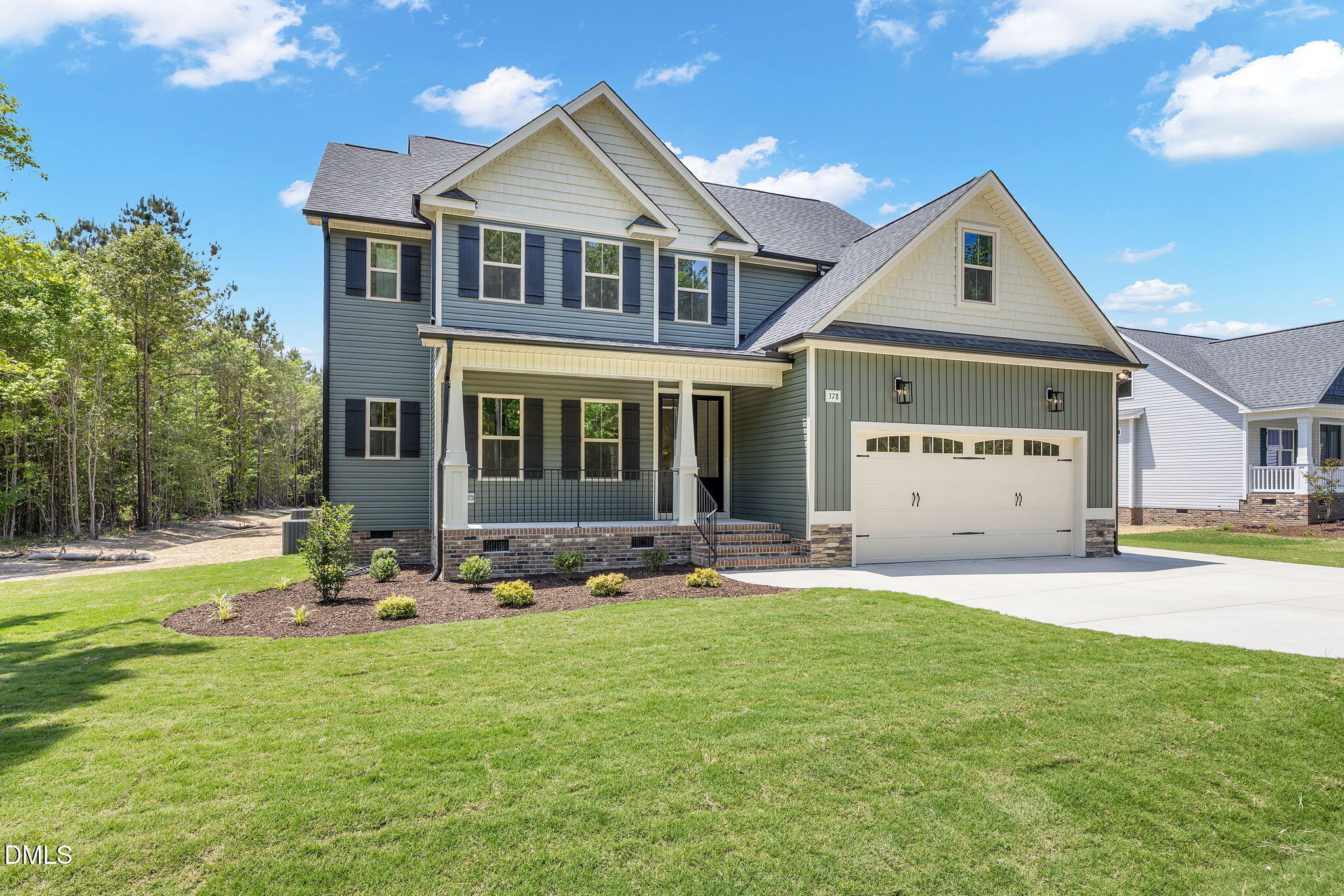 378 Freedom Ridge Drive Smithfield, NC 27577 - Photo 2 of 33 a front view of a house with a garden and yard