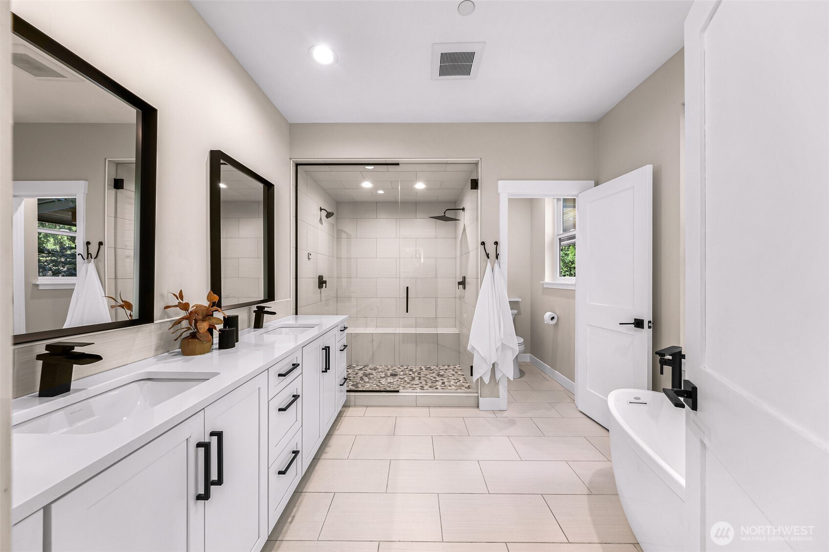 322 Manley Road Bellingham, WA 98229 - Photo 15 of 40 a spacious bathroom with a double vanity sink a mirror and a bathtub