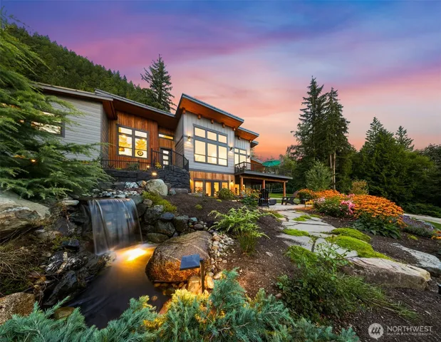 a view of a house with backyard and sitting area