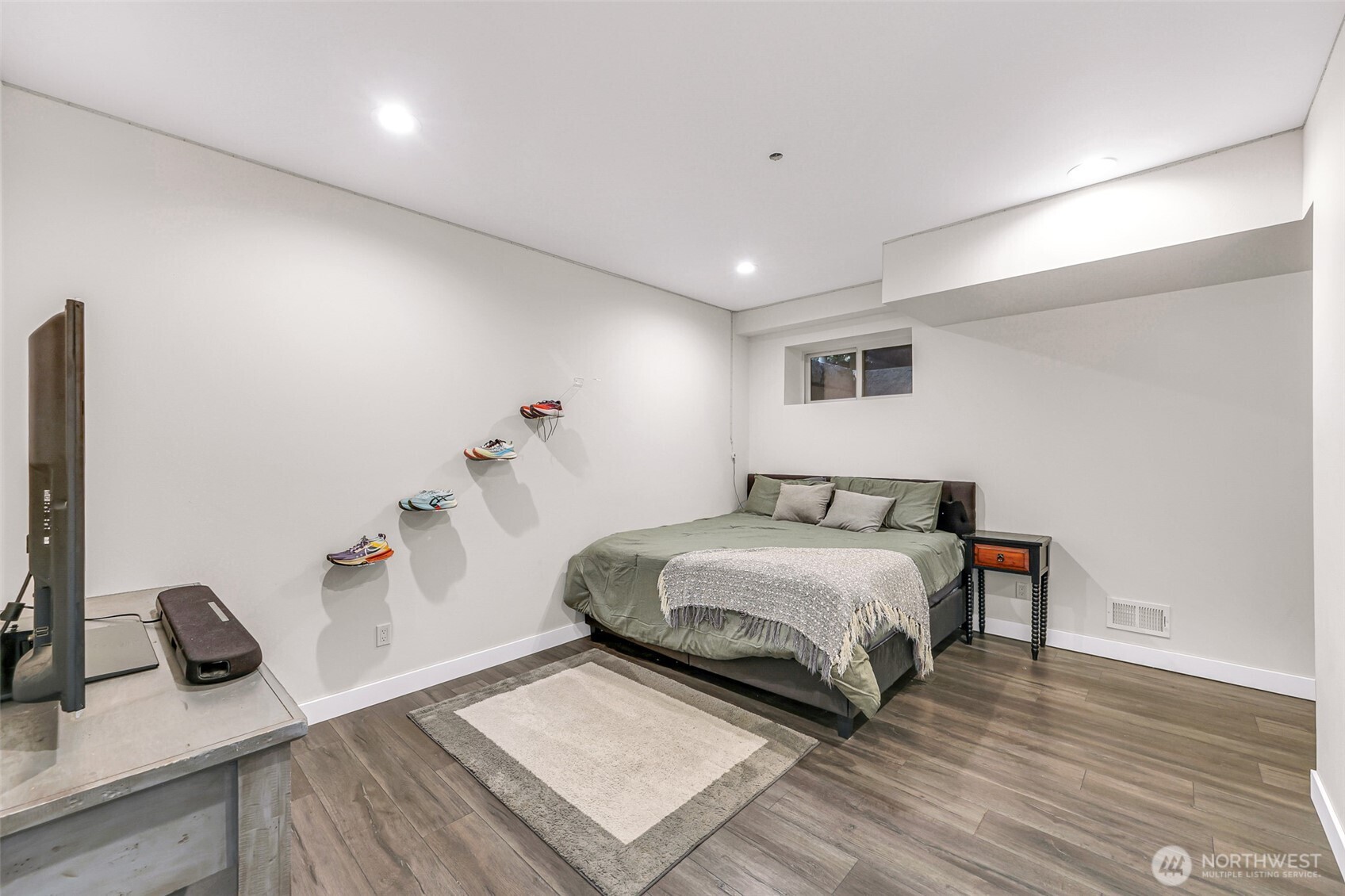 322 Manley Road Bellingham, WA 98229 - Photo 22 of 40 a bedroom with a bed wooden floor and a table