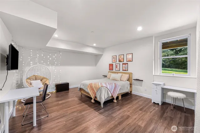 a living room with a bed furniture and a window