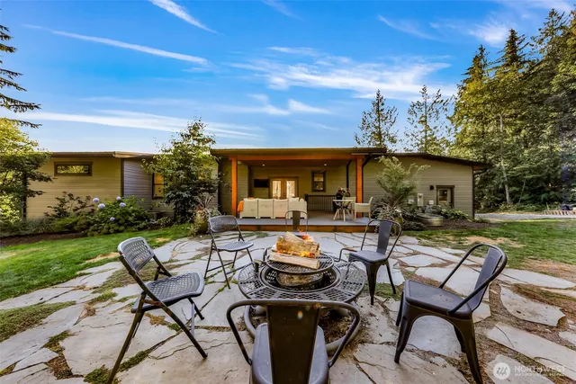 a backyard of a house with lots of green space and outdoor seating