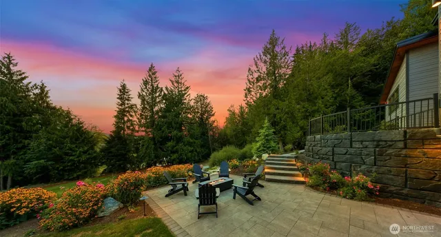 a view of a garden with plants and a bench