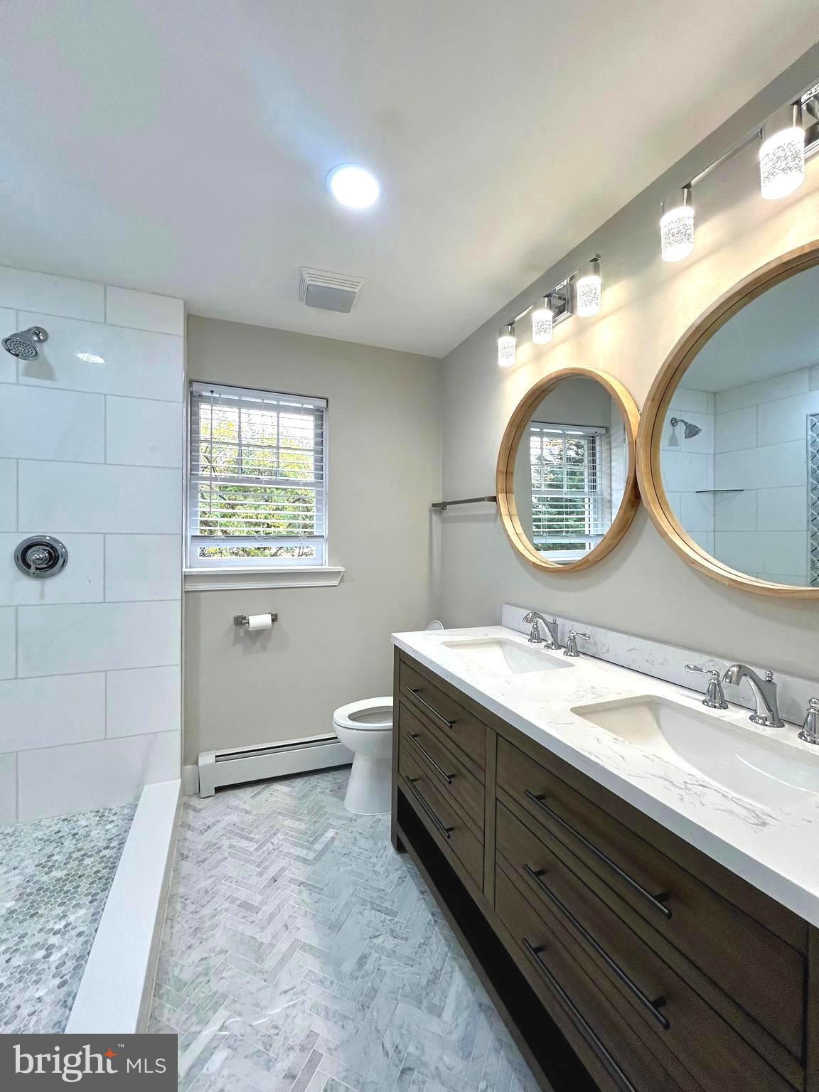 381 Upper Gulph Road Wayne, PA 19087 - Photo 9 of 17 a bathroom with a toilet a mirror and a shower