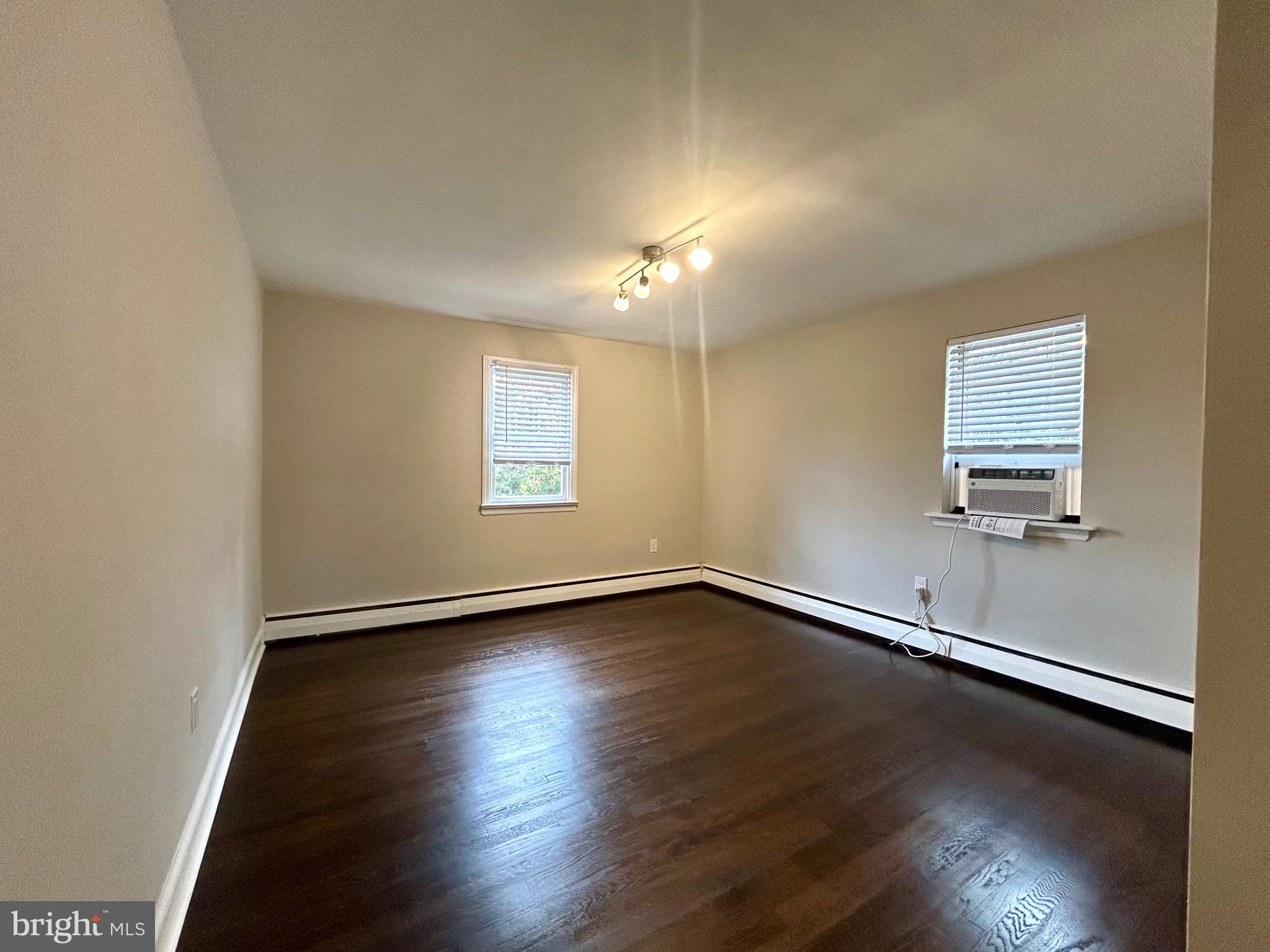 381 Upper Gulph Road Wayne, PA 19087 - Photo 10 of 17 an empty room with wooden floor and windows