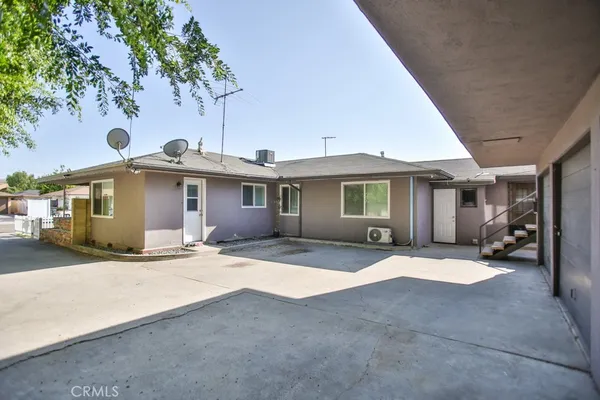 a front view of a house with yard patio and balcony