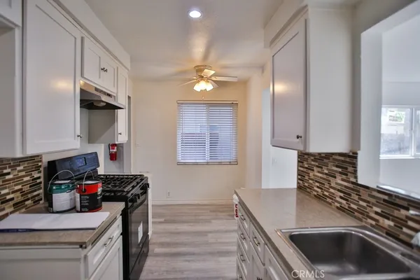 a kitchen that has a sink and a stove
