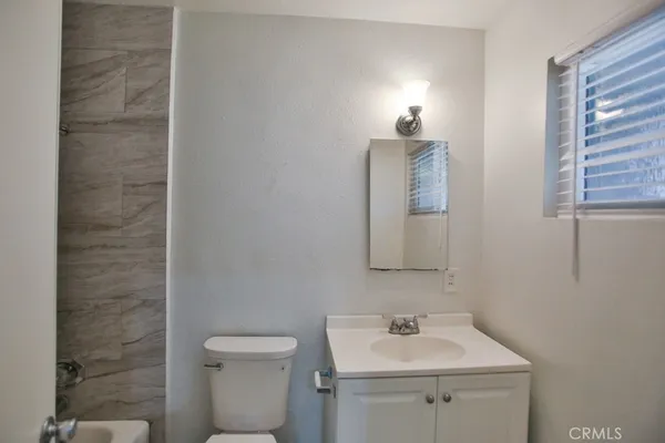 a bathroom with a sink toilet and mirror