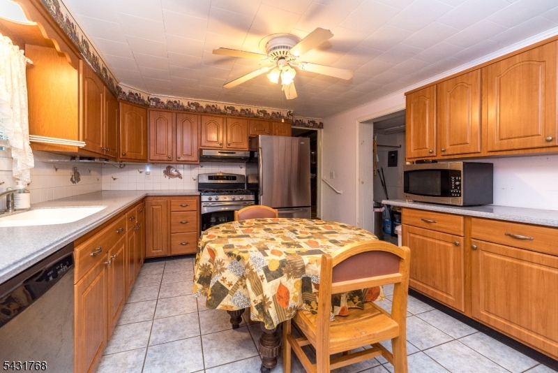 400 Mechlin Corner Road Pittstown, NJ 08867 - Photo 9 of 29 a kitchen with a sink cabinets and window
