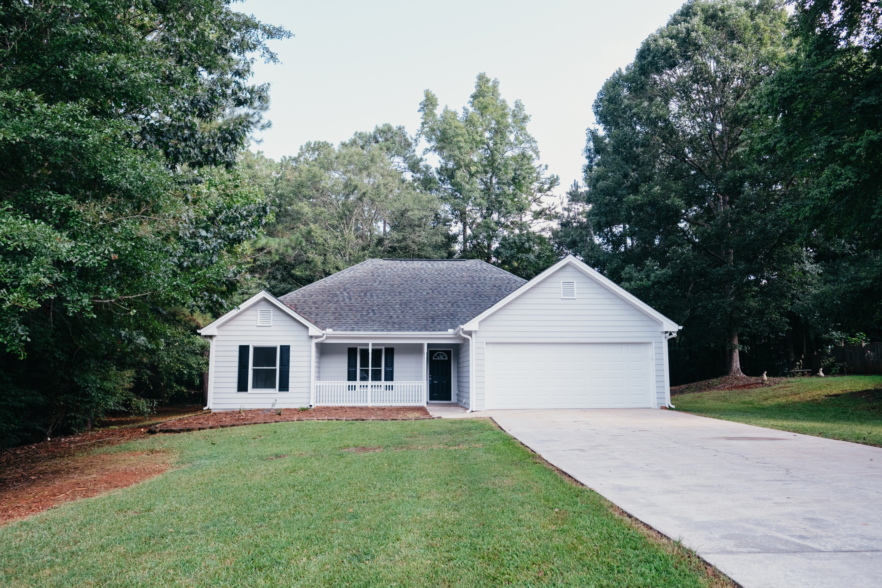 260 Cambridge Way Covington, GA 30016 - Photo 1 of 1 a front view of a house with a yard and trees
