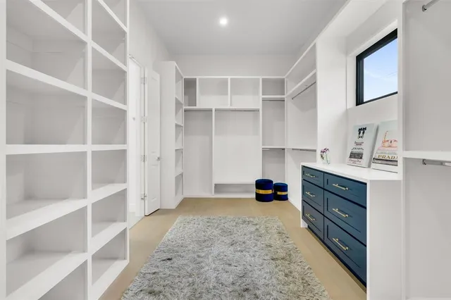 a spacious bathroom with a double vanity sink and a large mirror