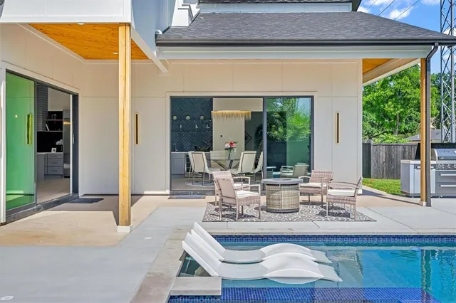 a view of an house with backyard space and balcony