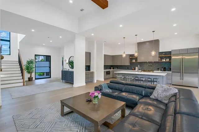 a living room with furniture and kitchen view