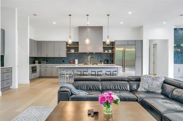 a kitchen with granite countertop a stove and white cabinets