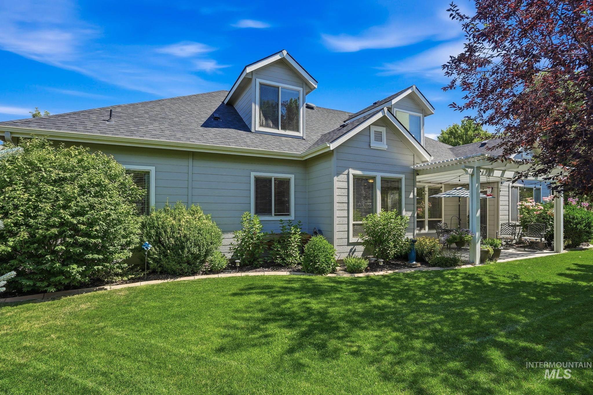 3969 North Hollymount Way Meridian, ID 83646 - Photo 39 of 47 Expansive green lawn bordering the light-colored siding of the home
