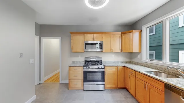 a kitchen with a sink stove and microwave