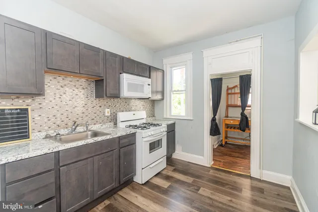 a kitchen with a sink cabinets and appliances