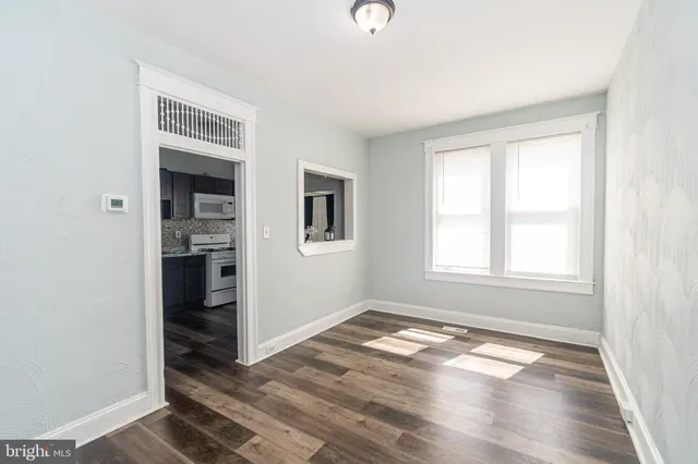 an empty room with windows and closet