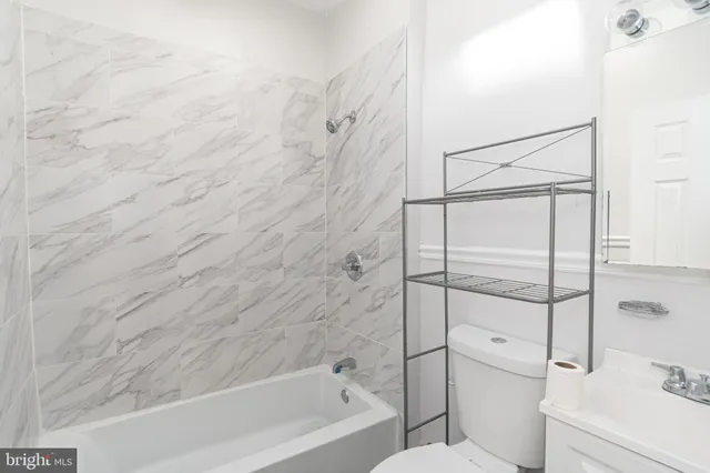 a bathroom with a bathtub and shower