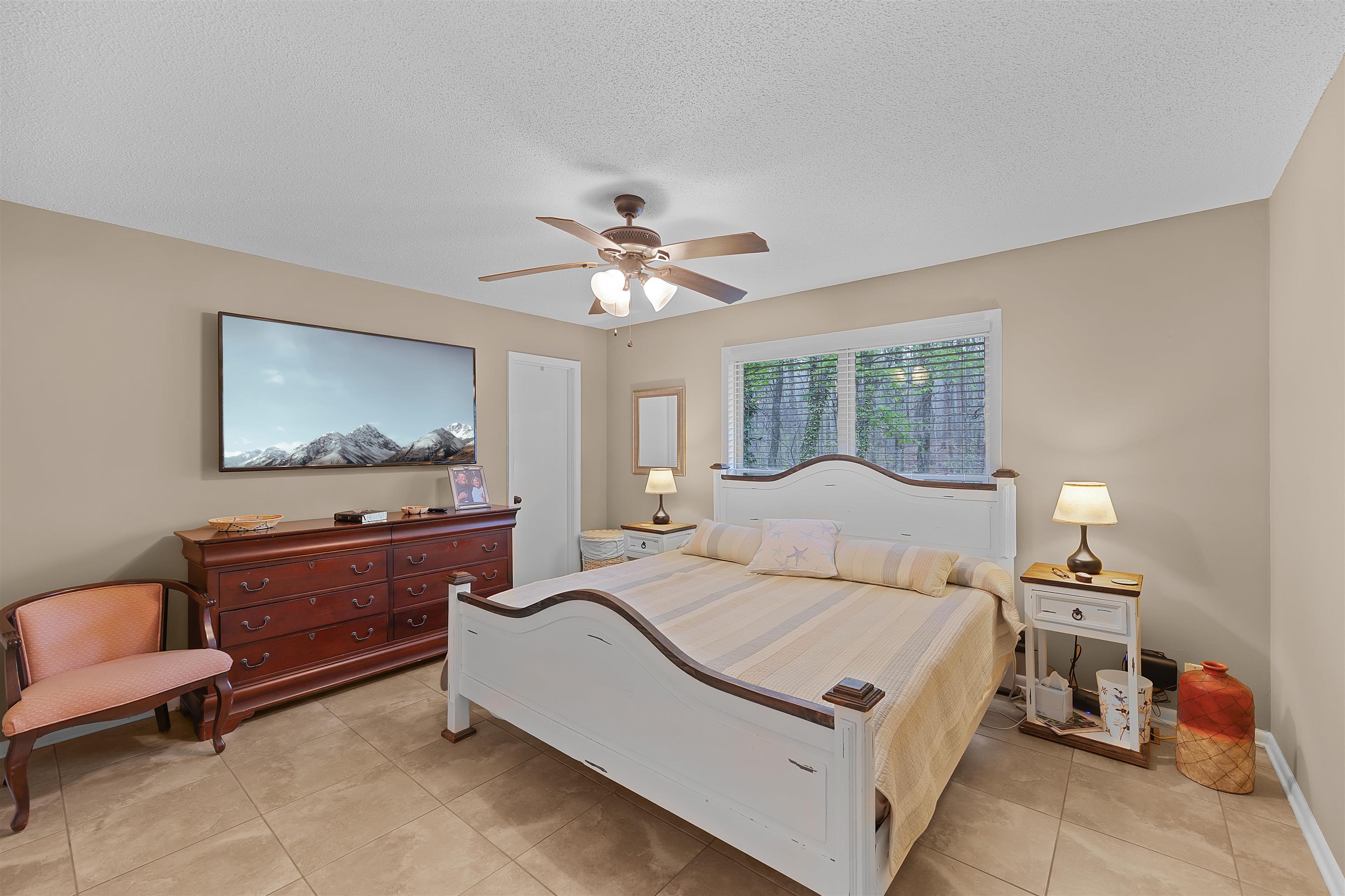 5 Cr 329 Road Iuka, MS 38852 - Photo 11 of 39 a bedroom with a large bed and a chandelier