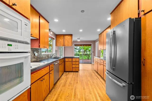 a view of an empty room with a fireplace and a window