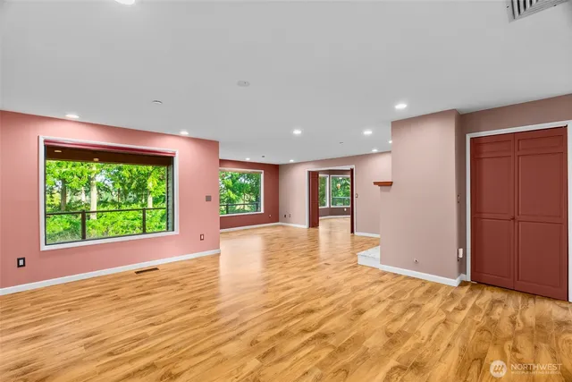 a spacious bedroom with a large bed and a potted plant