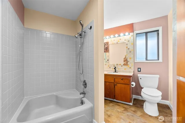 a view of workspace with a computer on a desk chair and a book shelf