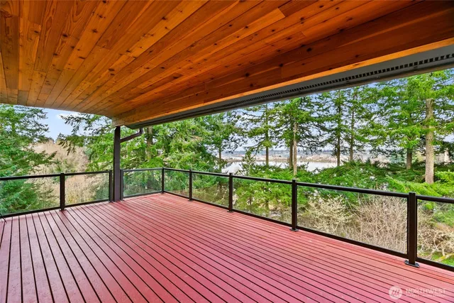 a spacious bedroom with a bed and a flat screen tv
