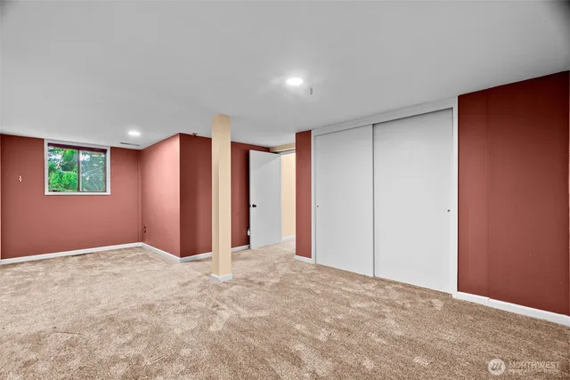 a bathroom with a granite countertop toilet sink and mirror