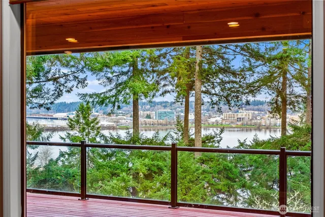 a kitchen with stainless steel appliances a sink and large windows