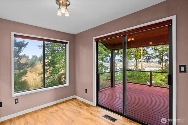 a kitchen with stainless steel appliances granite countertop a sink a counter space and a window